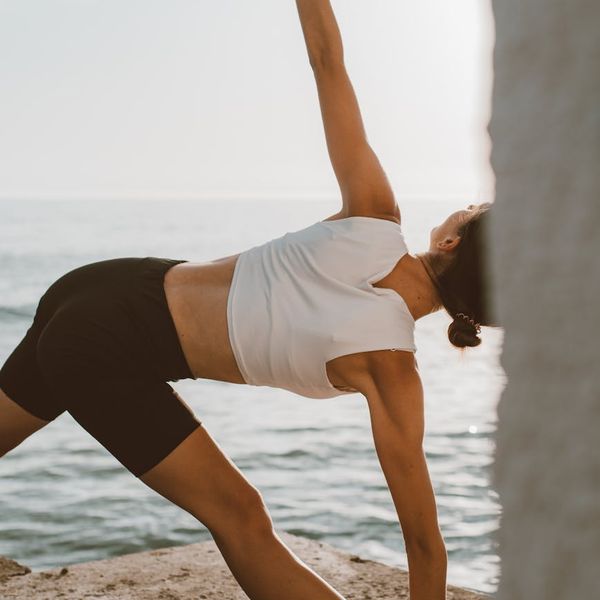 Person stretching outdoors during sunrise, showing improved flexibility.
